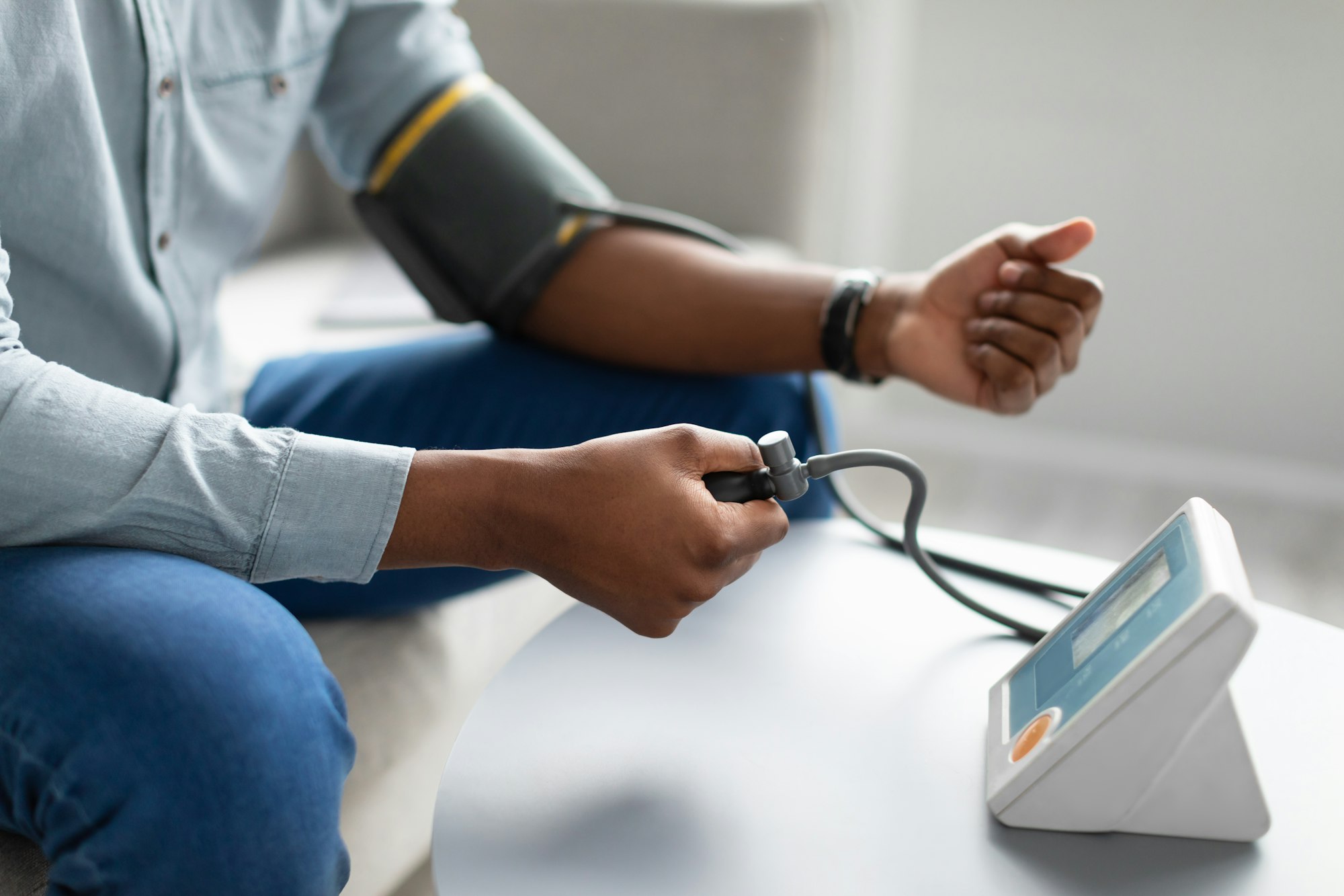 Black Man Measuring Arterial Blood Pressure Having Hypertension Indoors, Cropped
